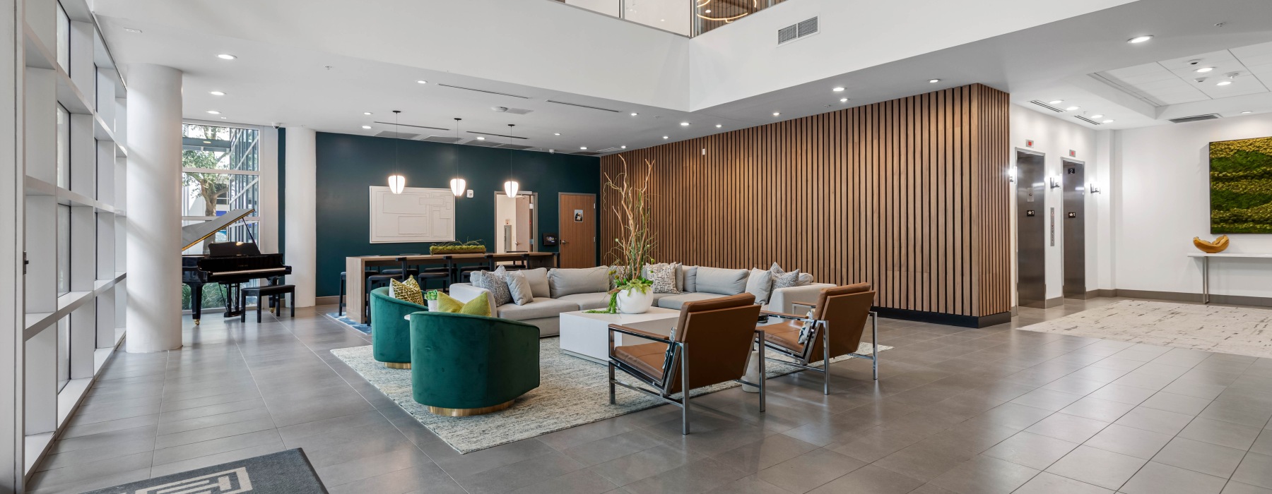 bright lobby with concierge counter next to elevators