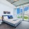 spacious, naturally lit bedroom with access to private balcony